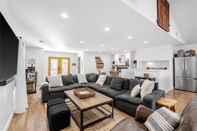 living room featuring recessed lighting, stairway, and light wood finished floors