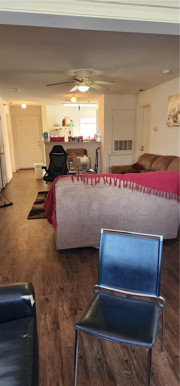 living room with wood-type flooring and ceiling fan