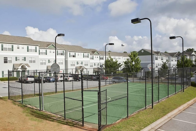 view of tennis court featuring basketball hoop