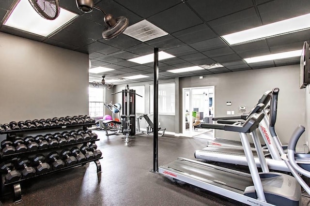 gym with a paneled ceiling