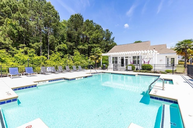 view of swimming pool with a patio and a pergola