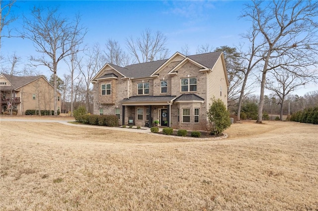 craftsman inspired home featuring a porch and a front lawn