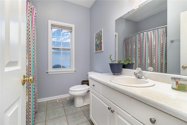 bathroom with vanity, tile patterned flooring, and toilet