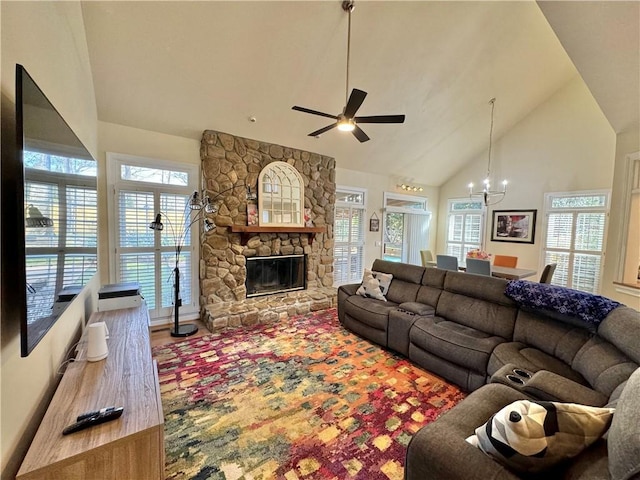 living room featuring a notable chandelier, a stone fireplace, high vaulted ceiling, and hardwood / wood-style flooring