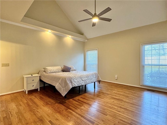 bedroom featuring hardwood / wood-style flooring, high vaulted ceiling, and ceiling fan