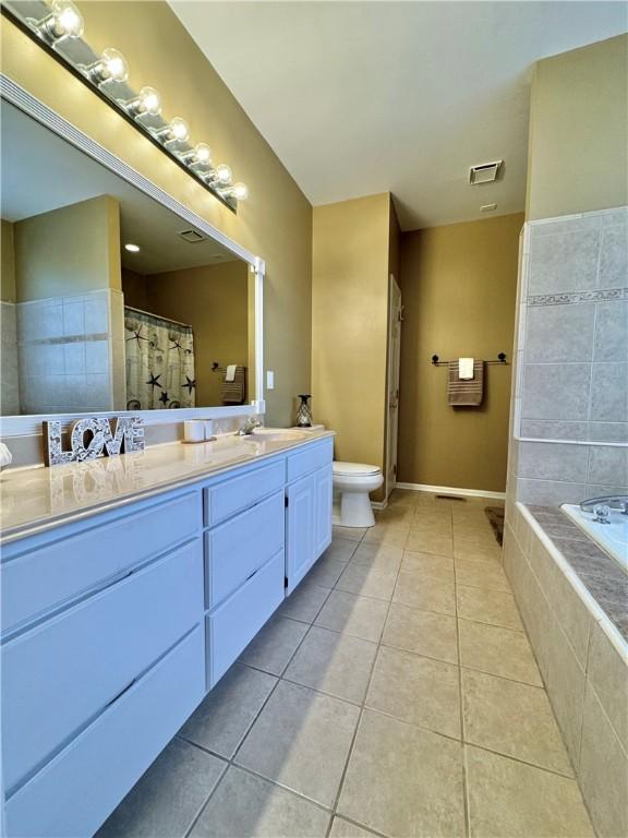 full bathroom featuring vanity, toilet, separate shower and tub, and tile patterned flooring