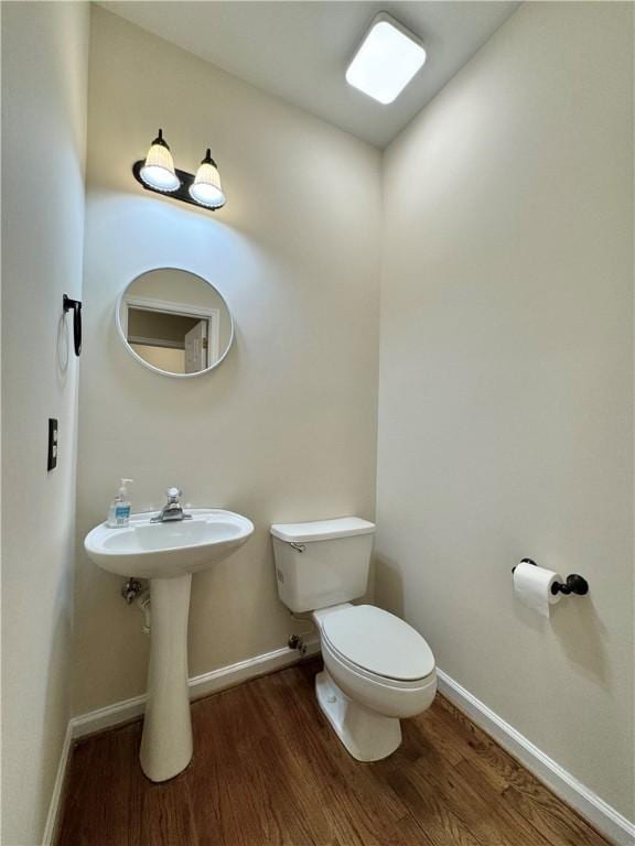 bathroom featuring hardwood / wood-style floors and toilet