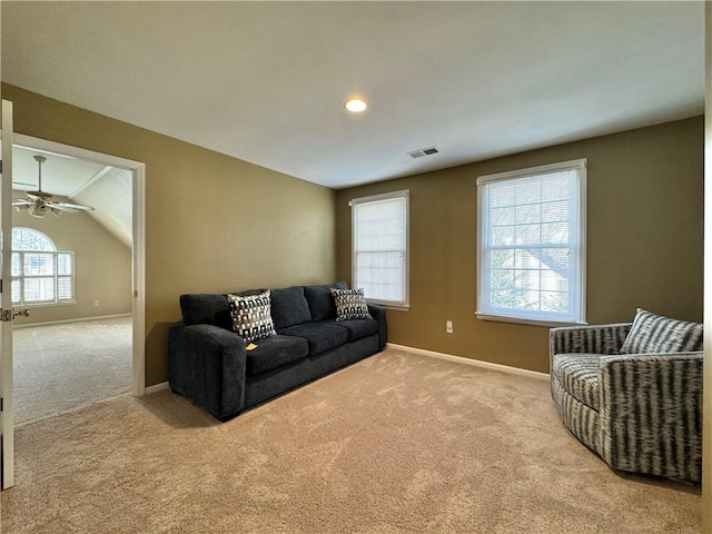 carpeted living room featuring vaulted ceiling and ceiling fan