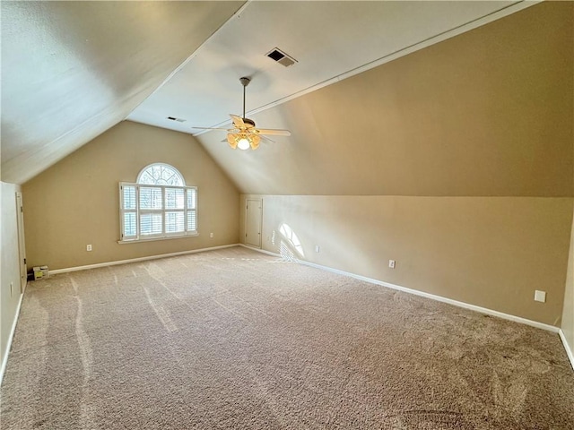 additional living space featuring ceiling fan, vaulted ceiling, and light carpet