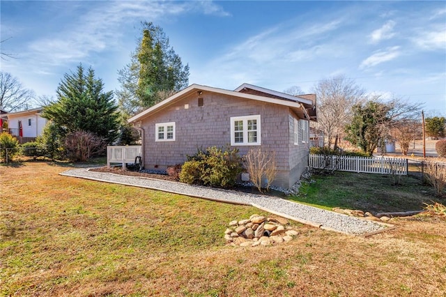 view of property exterior with a lawn