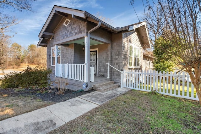 bungalow-style home with a front lawn and covered porch