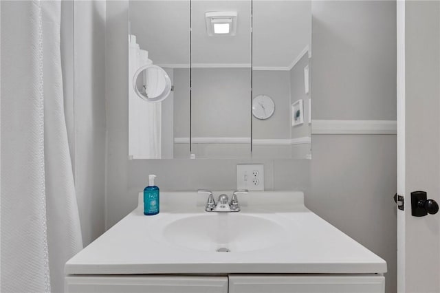 bathroom featuring crown molding and vanity