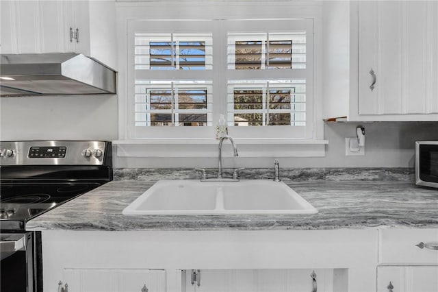 kitchen featuring white cabinetry, stainless steel range with electric stovetop, and sink