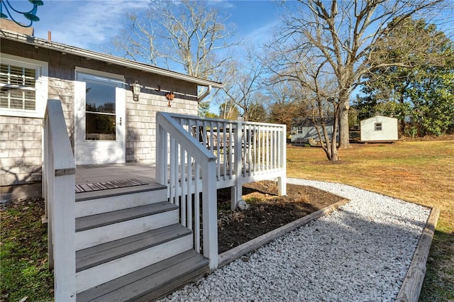 view of yard featuring a wooden deck and a storage shed