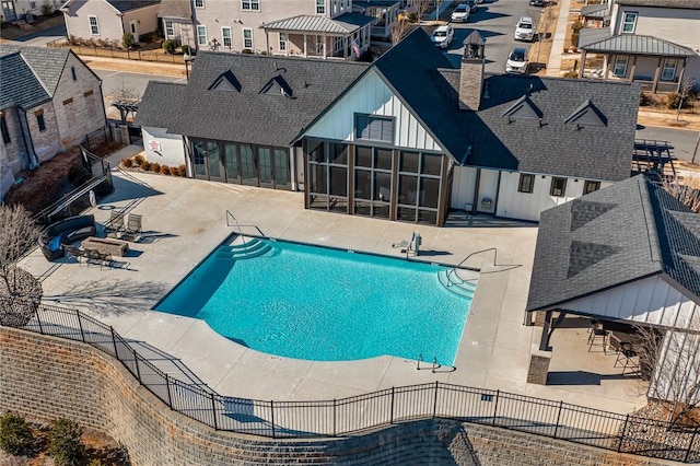 view of pool featuring a patio and a sunroom