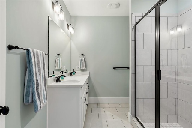 bathroom featuring tile patterned flooring, vanity, and a shower with door