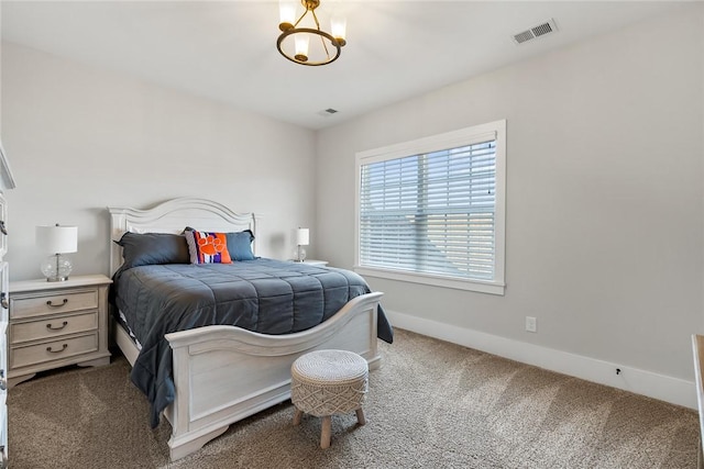 bedroom featuring an inviting chandelier and carpet floors