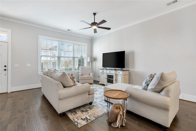 living room with dark wood-type flooring, ornamental molding, and ceiling fan