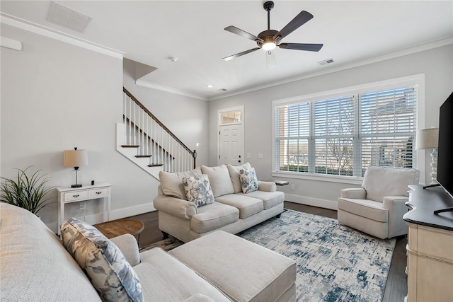 living room featuring crown molding, wood-type flooring, and ceiling fan