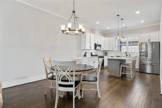 dining space featuring ornamental molding, sink, and dark hardwood / wood-style flooring