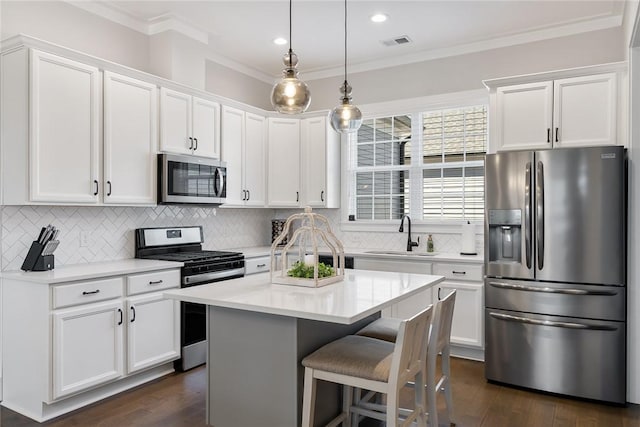 kitchen with sink, white cabinets, and appliances with stainless steel finishes