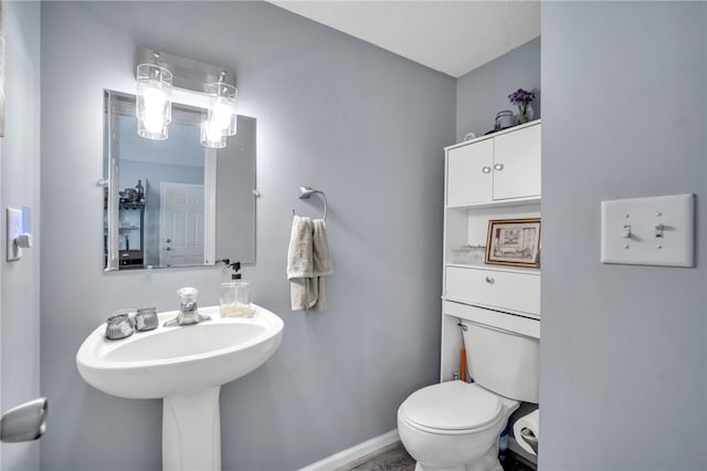 bathroom with toilet and a textured ceiling