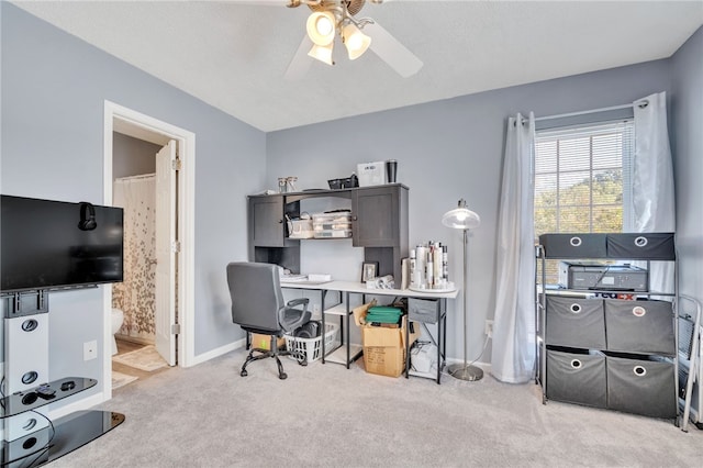 home office featuring light colored carpet and ceiling fan