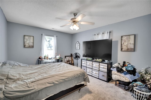 carpeted bedroom featuring a textured ceiling and ceiling fan