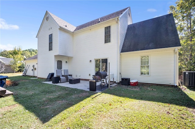 back of house with central AC unit, a yard, and a patio area