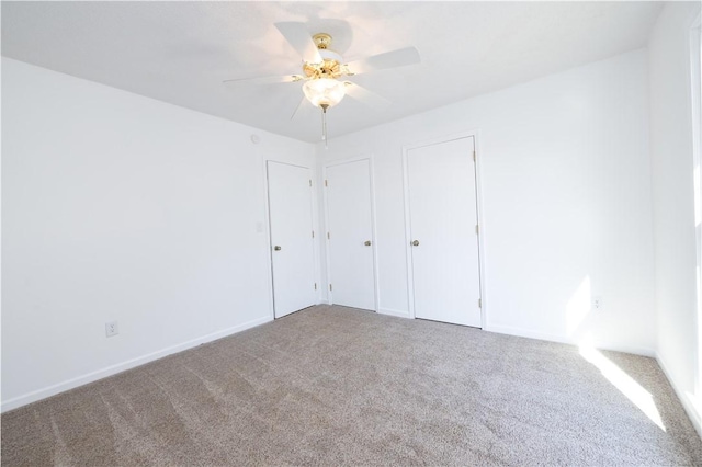 unfurnished bedroom with ceiling fan and carpet