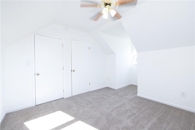 bonus room featuring lofted ceiling, light carpet, and ceiling fan