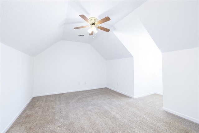 additional living space with lofted ceiling, light carpet, and ceiling fan