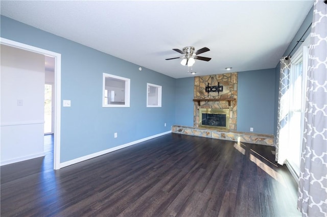 unfurnished living room with a fireplace, dark wood-type flooring, and ceiling fan