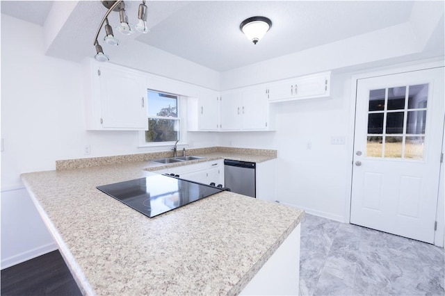 kitchen featuring dishwasher, sink, white cabinets, and kitchen peninsula