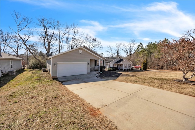 view of front of home with a garage, a front yard, and central AC unit