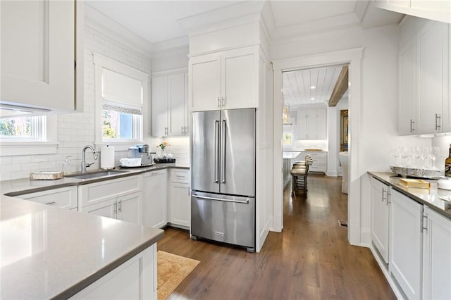 kitchen featuring white cabinetry, sink, high end refrigerator, backsplash, and dark wood-type flooring