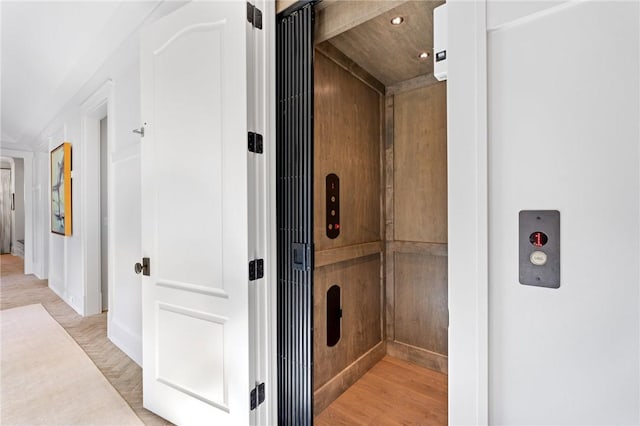 interior space with hardwood / wood-style flooring and elevator