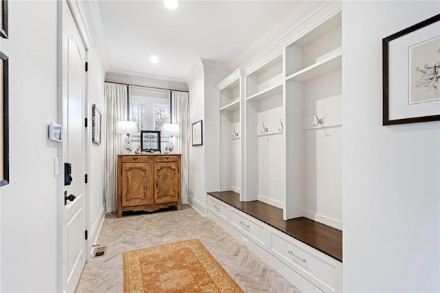 mudroom with ornamental molding and light parquet flooring