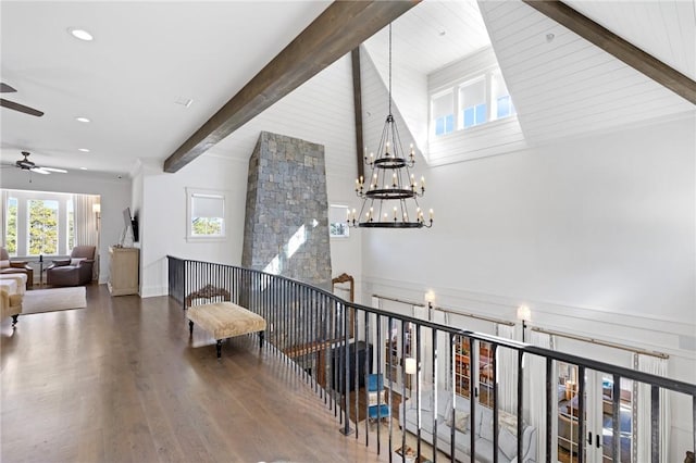 corridor featuring hardwood / wood-style flooring, a chandelier, and beamed ceiling