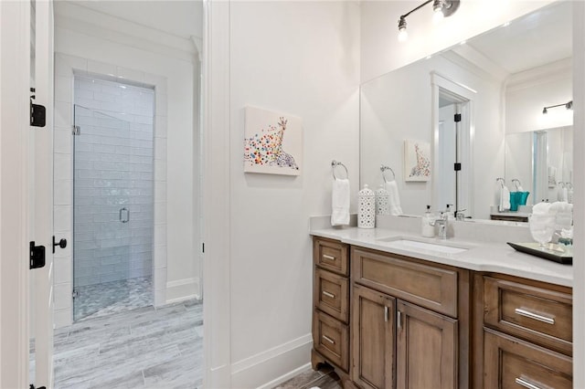 bathroom featuring ornamental molding, vanity, and walk in shower