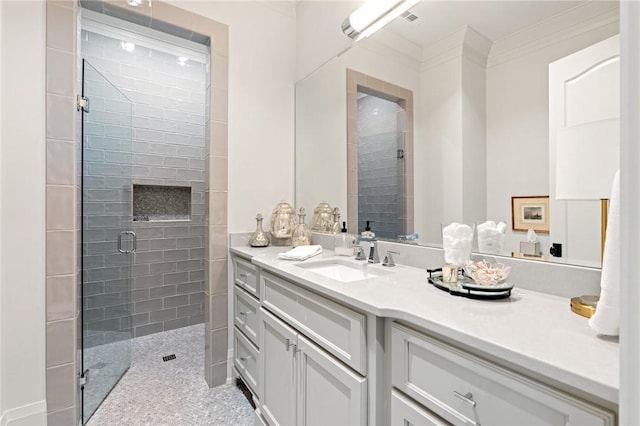 bathroom with vanity, ornamental molding, and walk in shower