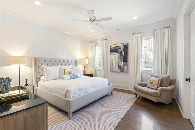 bedroom featuring dark wood-type flooring, ornamental molding, and ceiling fan