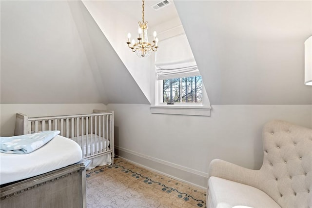 bedroom featuring a nursery area, a chandelier, and vaulted ceiling