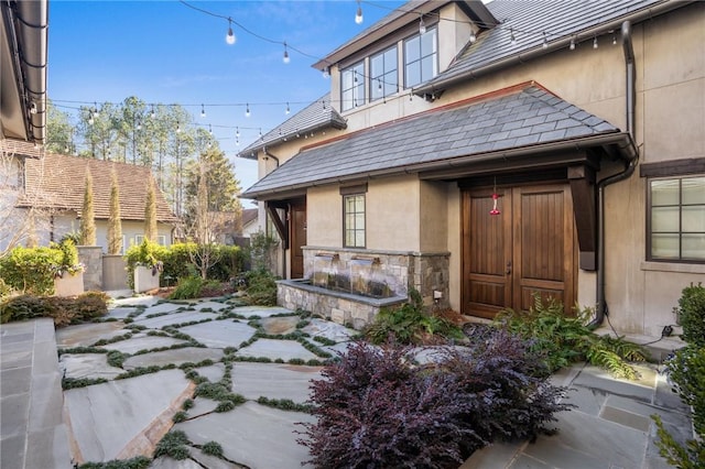 entrance to property featuring a patio