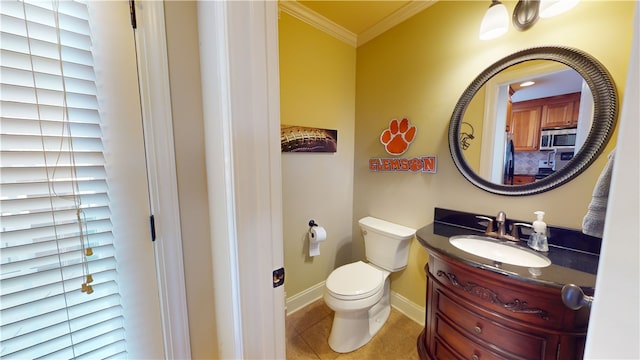 bathroom featuring vanity, tile patterned flooring, crown molding, and toilet