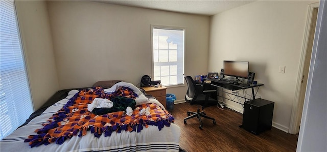 bedroom with dark wood-type flooring