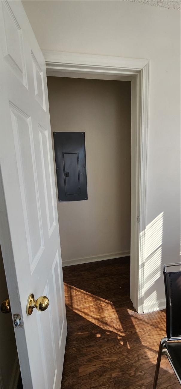 hallway with dark hardwood / wood-style floors and electric panel