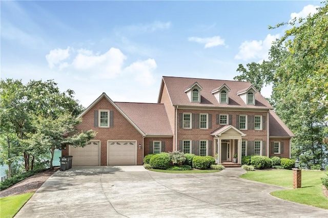 colonial-style house with a garage and a front lawn