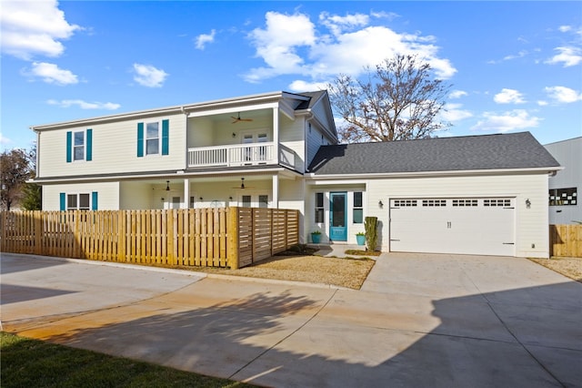 view of front of home with ceiling fan, a garage, and a balcony