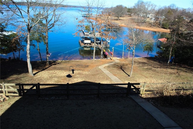 view of yard with a water view and a dock